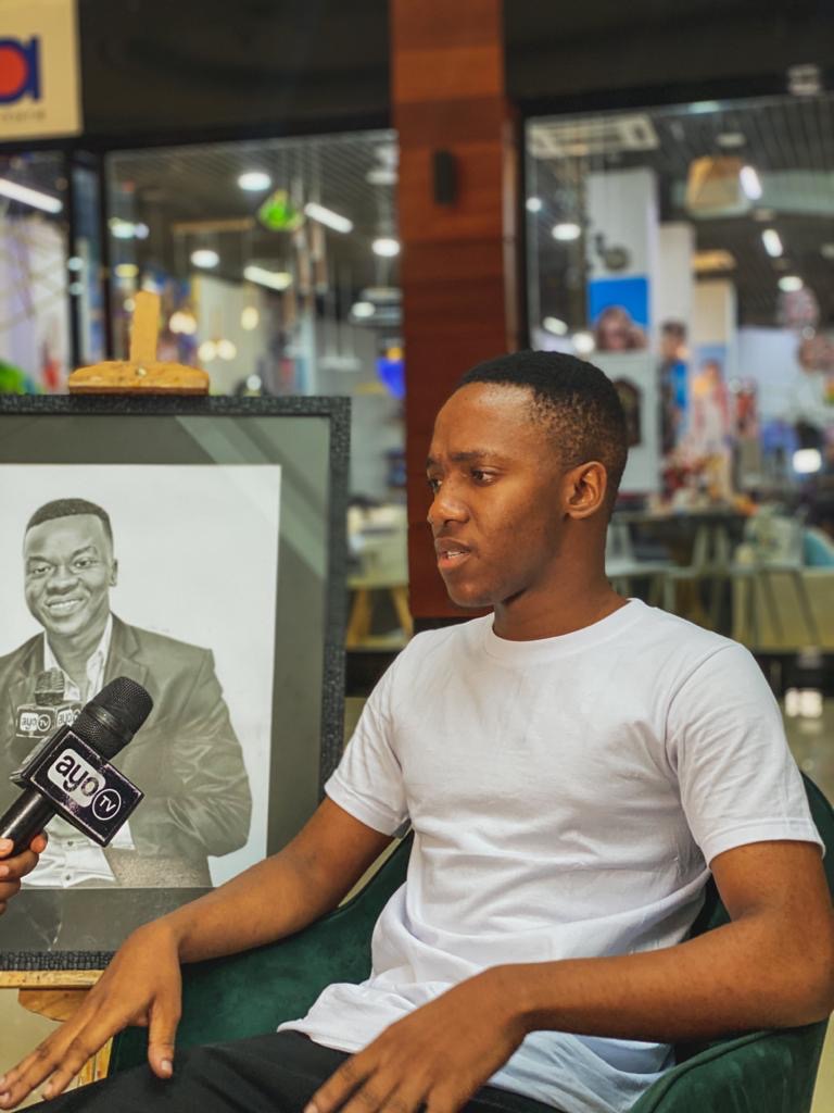 Moses Mwansasu with his graphite portrait
